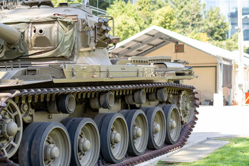 Side profile of historic military tank showing continuous tracks and turret © Em Neems Photography