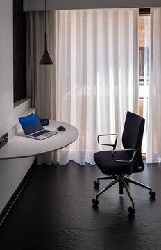 Remote Work Setup with Laptop and Desk in Modern Hotel Room Interior