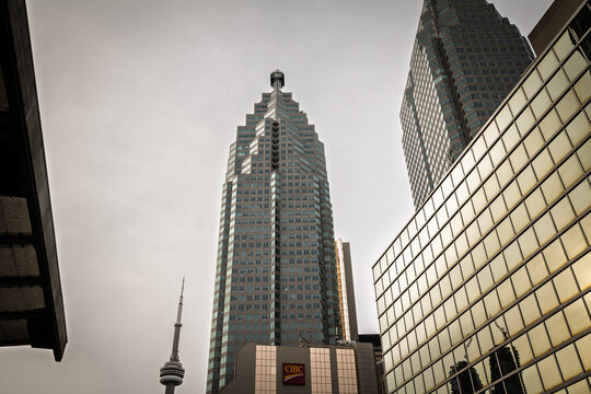 TORONTO, CANADA - DECEMBER 31, 2016: TD Bank tower, CIBC logo and CN Tower seen among glass skyscrapers in Toronto financial district, on Canadian banking, corporate and business activity in Canada.