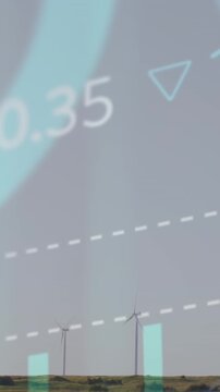 Animation of stock market data processing over spinning windmills on grassland against grey sky