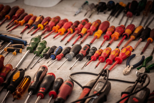 Types of screwdrivers and tools displayed for sale at market stall, different handle shapes, sizes and tip types for repair, maintenance, electrical work and DIY tasks ,on how to choose a screwdriver