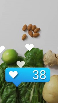 Social media likes animation over fresh vegetables and nuts on white background