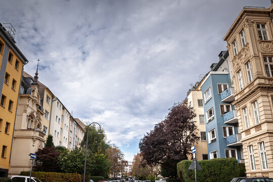 Typical residential street of Lutticher Strasse in Belgisches Viertel district in a central street of Colgone, Germany, in a Western European background and cars parked.