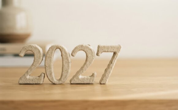 Minimalist 2027 year numbers on wooden table for upcoming future planning and new year concepts
