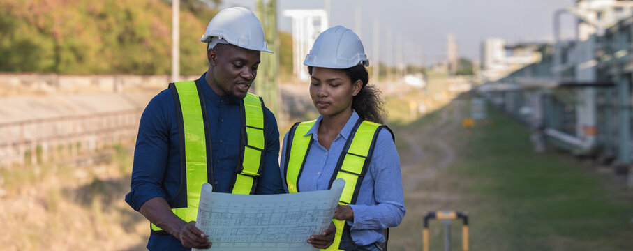 Engineer survey team checking construction project inspection work construction site .Team Civil engineer working outdoor next to the power plant.