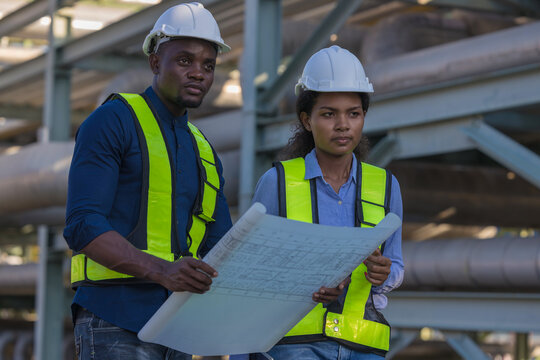 Engineer survey team checking construction project inspection work construction site .Team Civil engineer working outdoor next to the power plant.