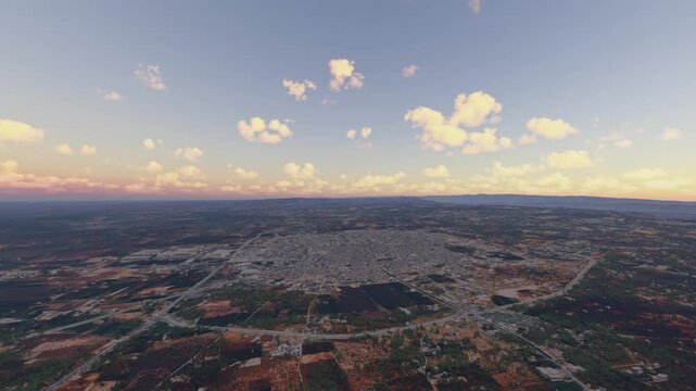 Circular aerial view at sunrise of Idlib City. Syria