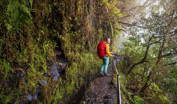 Hiker on a Levada, PR9 Levada do Caldeir&atilde;o Verde, Madeira, Portugal