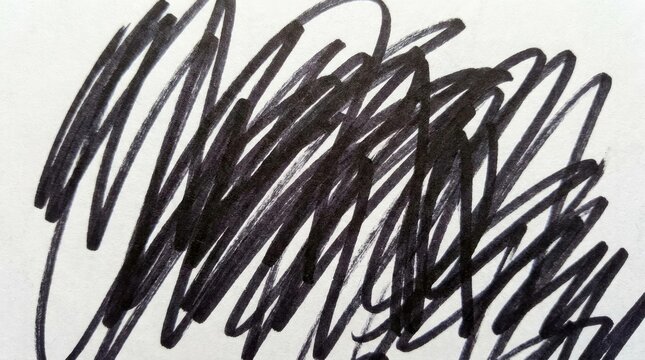 Black marker scribble on white paper background