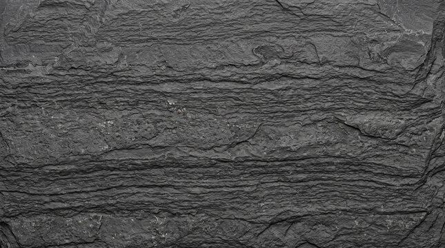 Dark grey slate rock texture with natural stone layers and rough geological surface.
