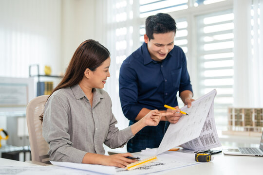 professional architects, engineers working on construction project of building .