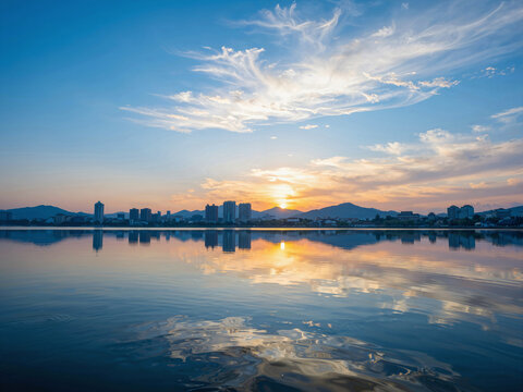 Sunset reflection of city skyline on a calm lake