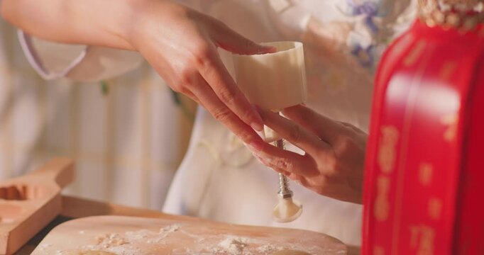 Brushing egg liquid on handmade mooncake for Mid‑Autumn Festival