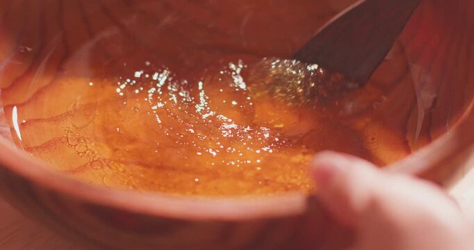 Brushing egg liquid on handmade mooncake for Mid‑Autumn Festival