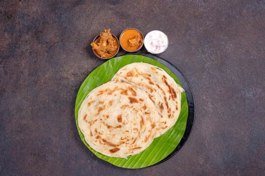Flaky South Indian parotta with flavorful kurma