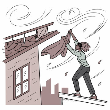 Woman struggling to hang laundry on a rooftop during a powerful windstorm with struggle
