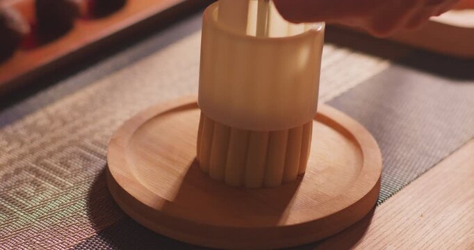 Brushing egg liquid on handmade mooncake for Mid‑Autumn Festival