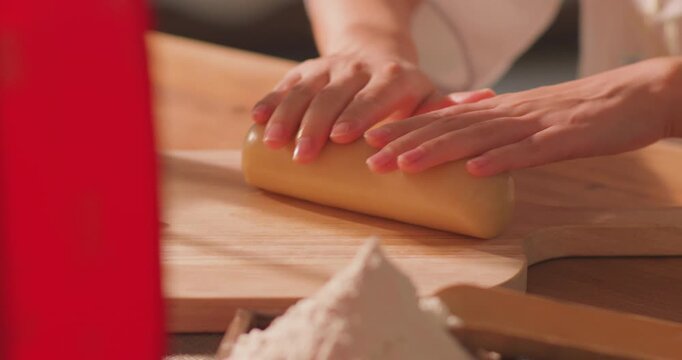 Brushing egg liquid on handmade mooncake for Mid‑Autumn Festival
