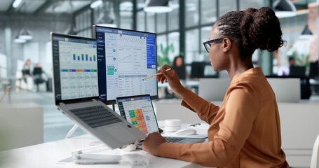 Obraz premium Insurance Underwriter Carefully Reviews Policy Data Using Laptop