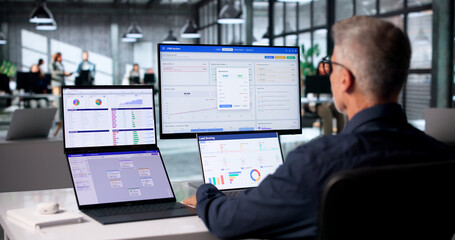 Sales Analyst Studies Customer Data On Touchscreen