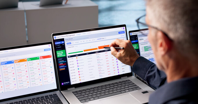 Revenue Cycle Manager Reviews Patient Claims Data On Laptop
