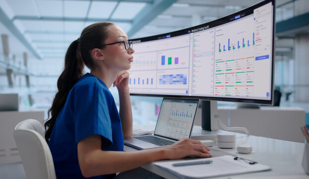 Woman In Uniform Works On Laptop