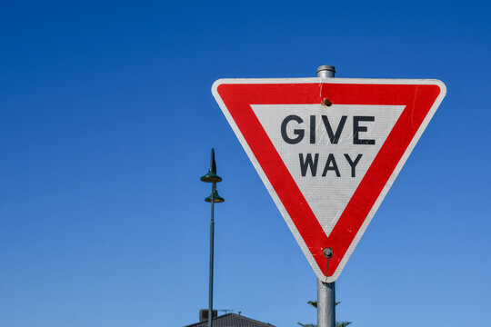 give way sign against blue sky