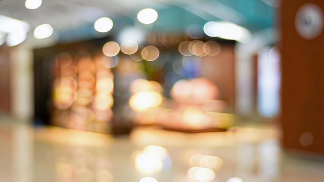 A blurred indoor space features soft bokeh lighting and warm tones, creating a gentle, unfocused ambient scene.