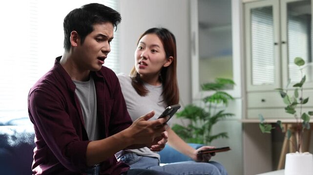 A couple had an argument over their cell phones while sitting on the sofa in the living room.