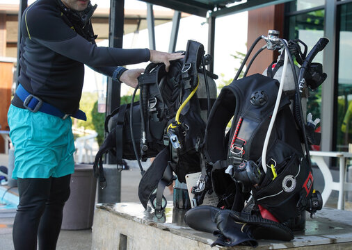Scuba diving equipment with oxygen tank near swimming pool