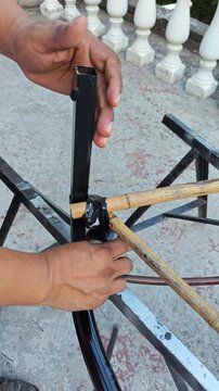 Fastening Bamboo Poles to Iron Frame with Cable Ties and Tape