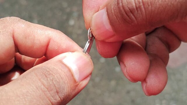 Close Up of Hands Inspecting Metal Key Rings Hardware