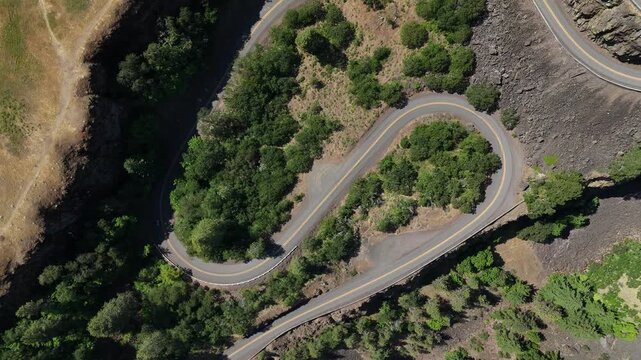 Car Driving Along Winding Hairpin Turn on Mountain Road aerial drone 4k video