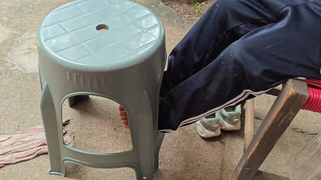 Bare Children Feet Resting While Sitting On Wooden Bench