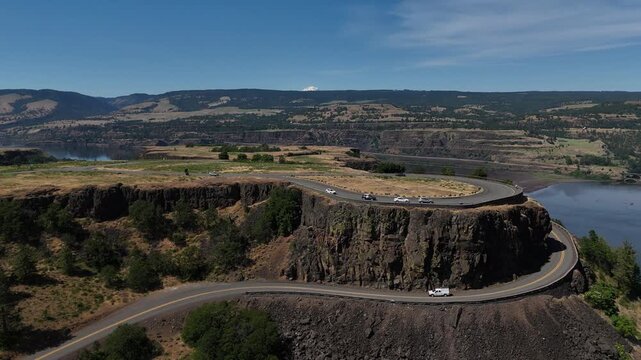 Rowena Crest viewpoint with the iconic horseshoe curve on the Historic Columbia River Highway overlooking the Columbia River Gorge and Mount Hood in the distance 4k aerial drone video