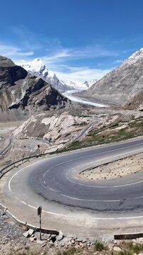 Zanskar, India : Panoramic footage of mountain road in Pensi La, famous mountain pass in Zanskar of Ladakh, India with dramatic snow mountain and Drang drung glacier on sunny day in the background