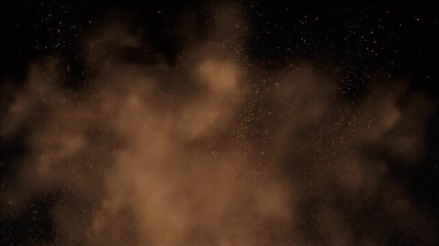 Brown dust particles explode outwards against a black background.