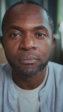 Contemplative male face in soft light setting, Expressive portrait of man showing resilience and reflection