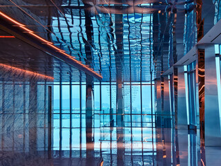 Obraz premium Spacious glass atrium with reflections on polished floor and panoramic windows. Empty lobby features