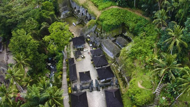 Aerial drone view of Gunang Kawi Sebatu temple complex surrounded by tropical jungle in Bali Indonesia.