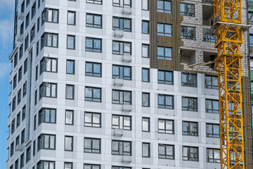 Construction of a modern high-rise building under a clear blue sky © beholdereye