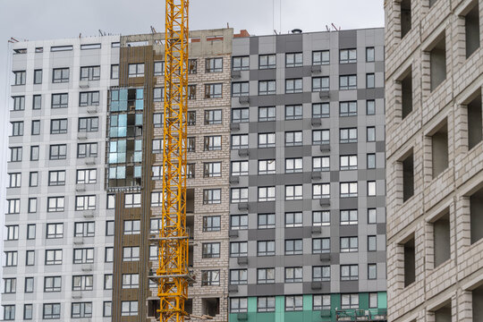 Construction of modern buildings showcasing a vibrant skyline in an urban setting during a cloudy afternoon
