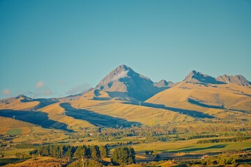 Obraz premium Cotopaxi volcano peak over golden hills in Ecuador