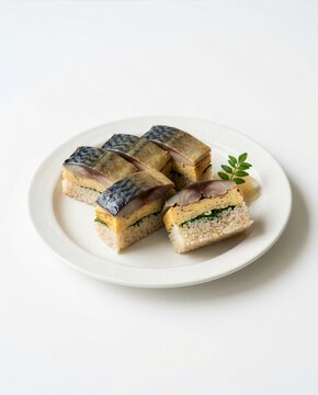 Traditional Japanese pressed mackerel sushi saba zushi with egg layer on a white plate isolated on white background