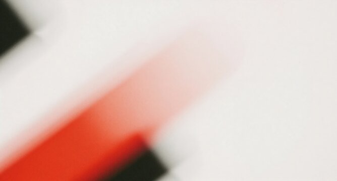 Abstract diagonal red motion blur streak on white and black contrasting background with diagonal line