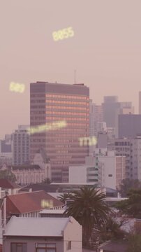 Animation of multiple changing numbers floating against aerial view of cityscape