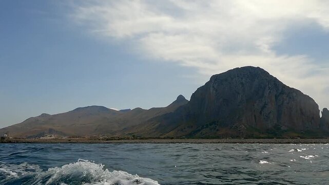 Scenic view of San Vito Lo Capo coastline seen from a moving boat during summer.