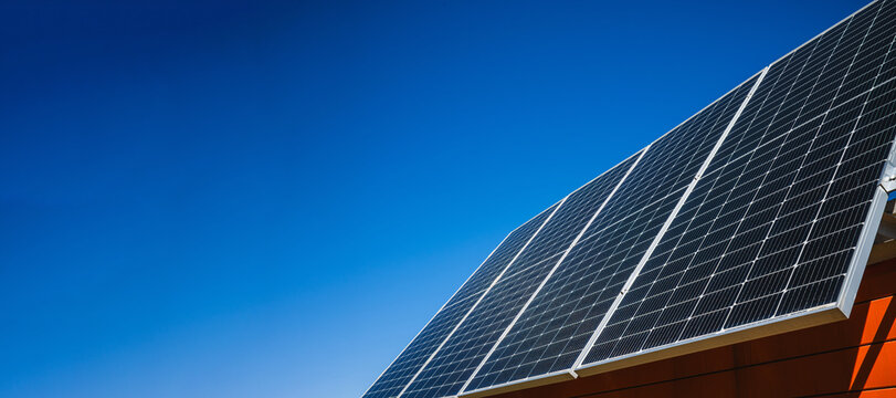 Rooftop Solar Panel Installation with copy space sky background