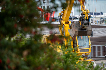 Yellow Excavator at Urban Construction Site © Nataliia