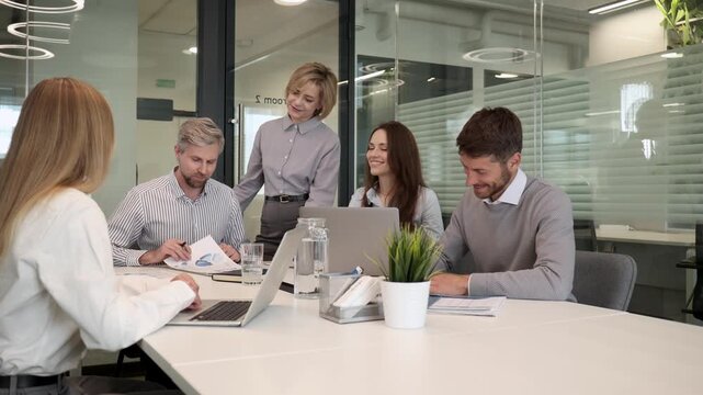 Business team discussing together business plans in office.